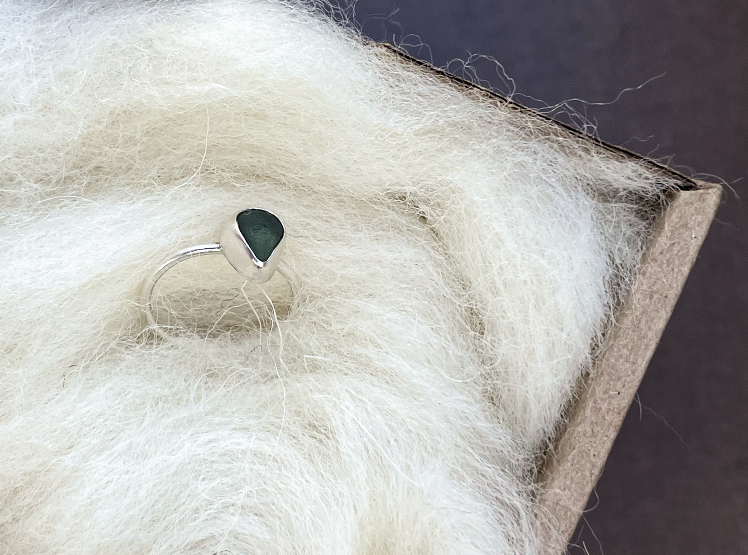 A silver ring packaged in our Luxury Cheviot British Wool
